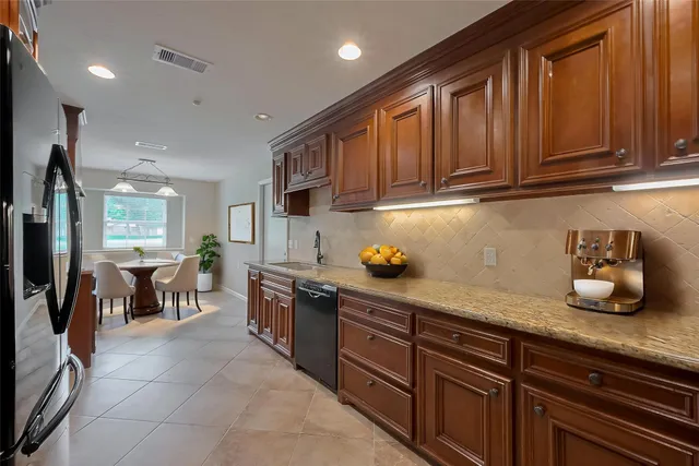 a kitchen with granite countertop cabinets and window