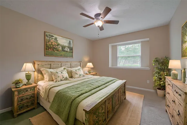 a bedroom with bed and a chandelier