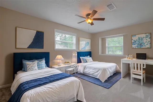 a bedroom with two beds and a chandelier