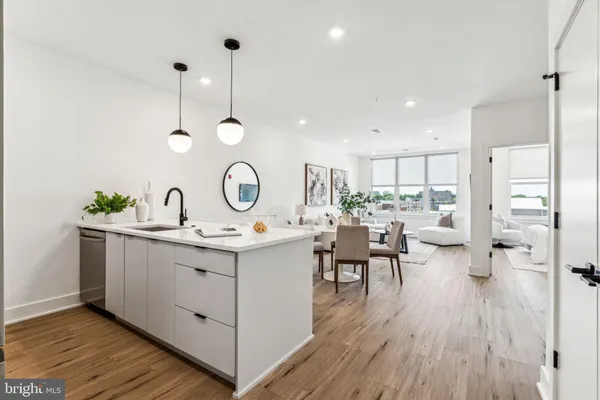 a view of kitchen island sink and wooden floor