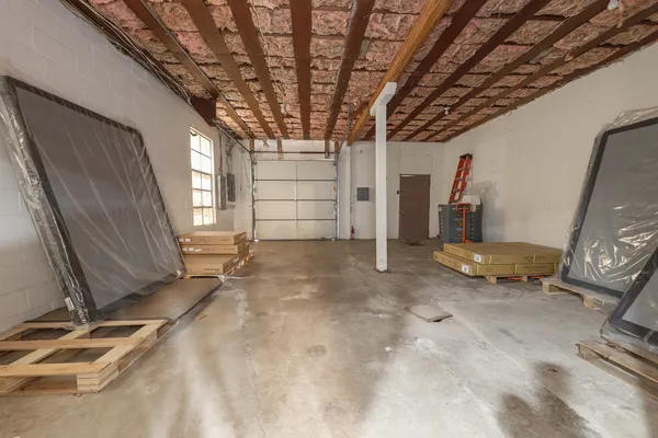 a view of a room with wooden floor and windows
