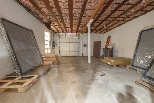 a view of a room with wooden floor and windows