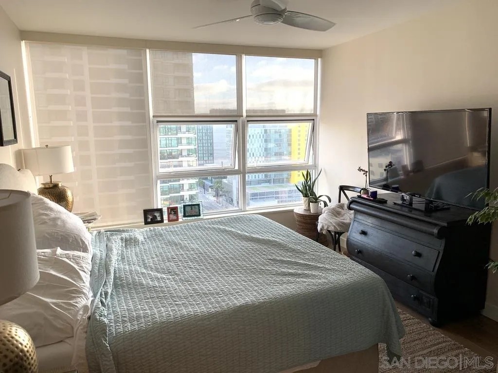 1325 Pacific Highway, Unit 1703 San Diego, CA 92101 - Photo 13 of 18 a bedroom with a bed and a flat tv screen next to a window