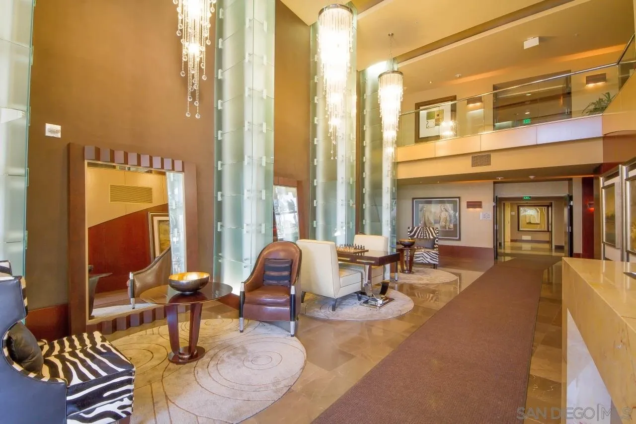 1325 Pacific Highway, Unit 1703 San Diego, CA 92101 - Photo 4 of 18 a living room with furniture or couch and a dining table next to a window