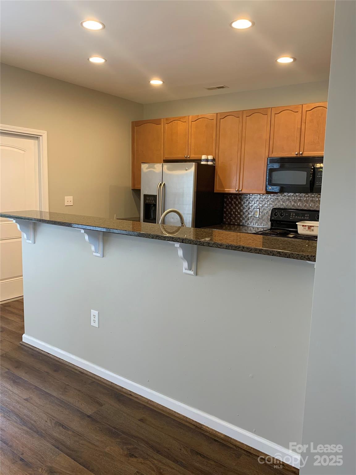 1131 Central Park Circle Davidson, NC 28036 - Photo 14 of 21 a view of kitchen with stainless steel appliances wooden floor and a sink