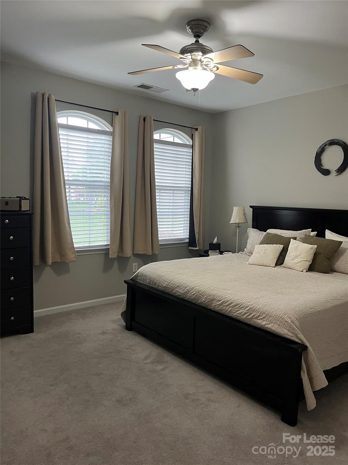 1131 Central Park Circle Davidson, NC 28036 - Photo 16 of 21 a bedroom with a bed lamp closet on desk and a window