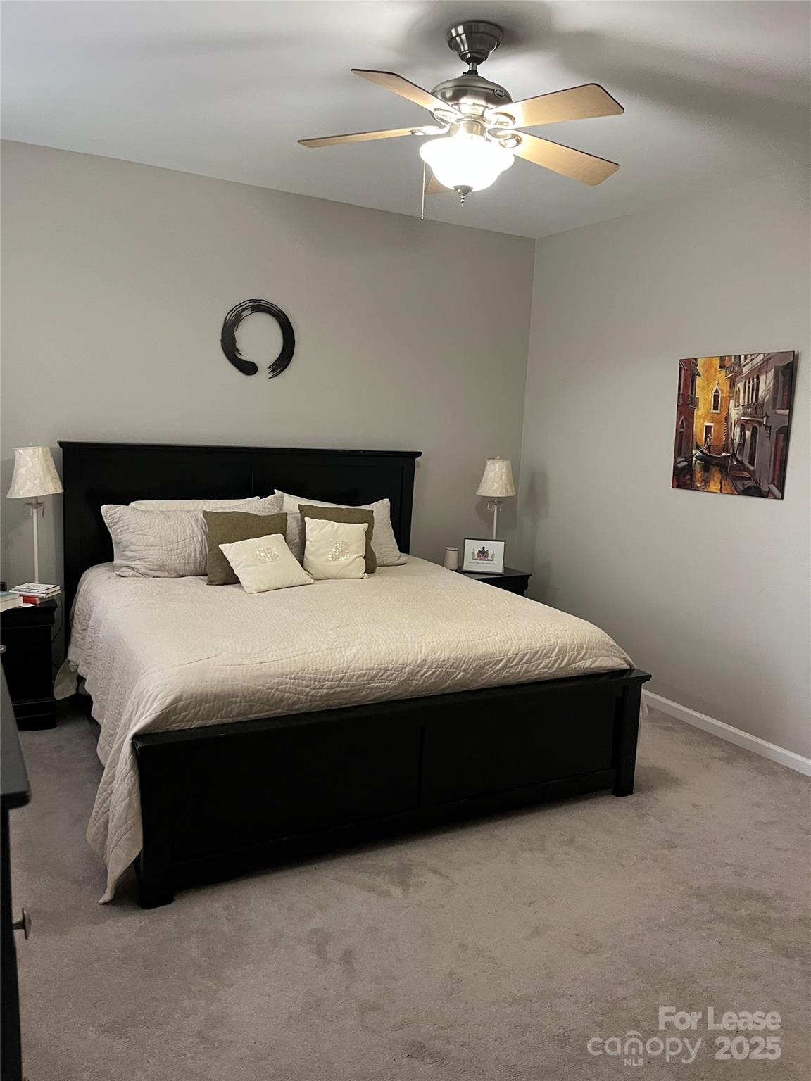 1131 Central Park Circle Davidson, NC 28036 - Photo 17 of 21 a bedroom with a bed and a ceiling fan