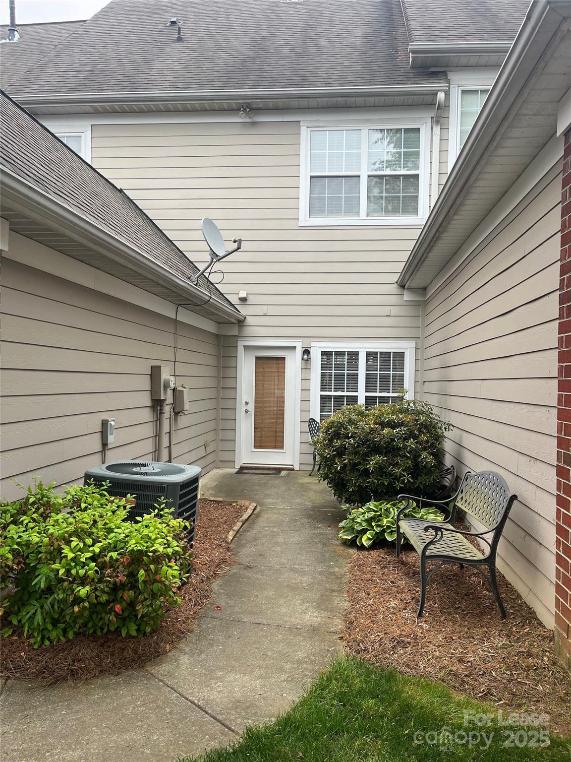 1131 Central Park Circle Davidson, NC 28036 - Photo 4 of 21 a front view of a house with a yard and outdoor seating