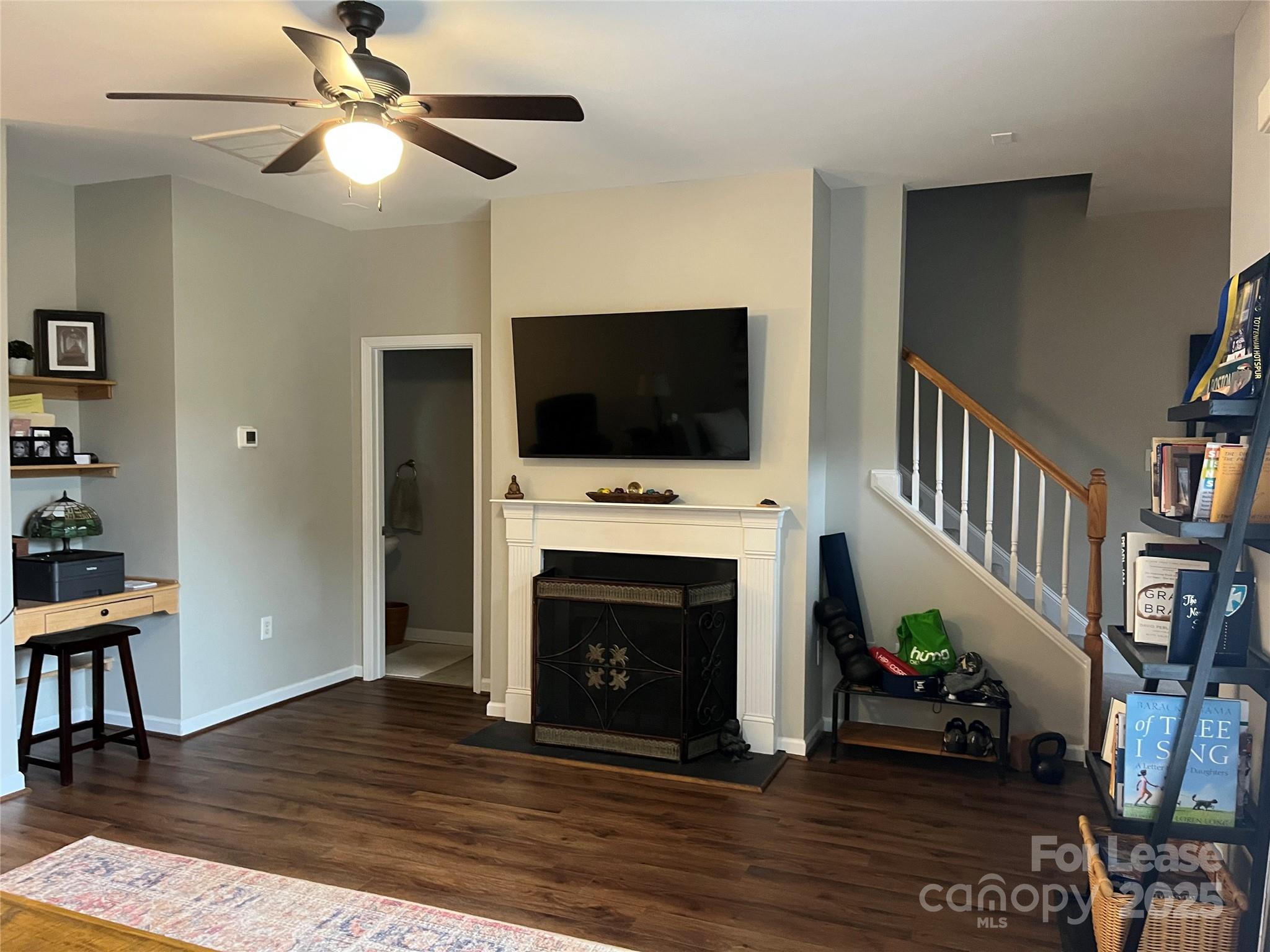 1131 Central Park Circle Davidson, NC 28036 - Photo 6 of 21 a living room with furniture a fireplace and a flat screen tv