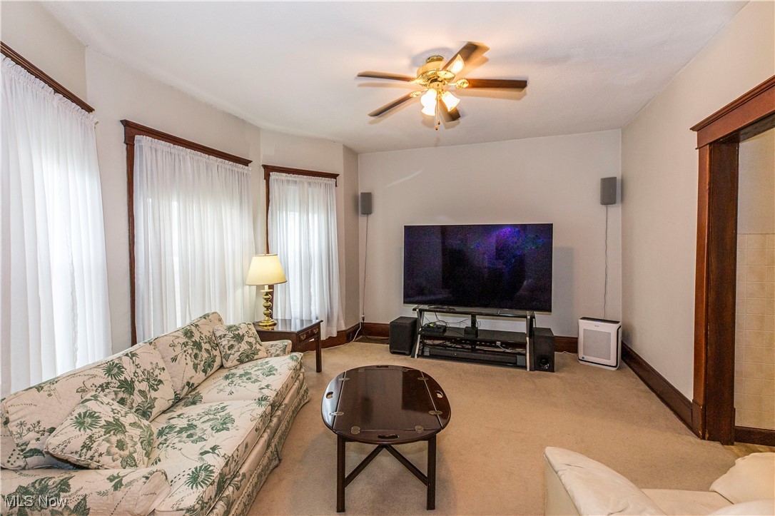 749 Amherst Road Northeast Massillon, OH 44646 - Photo 15 of 41 Living room with ceiling fan and carpet flooring