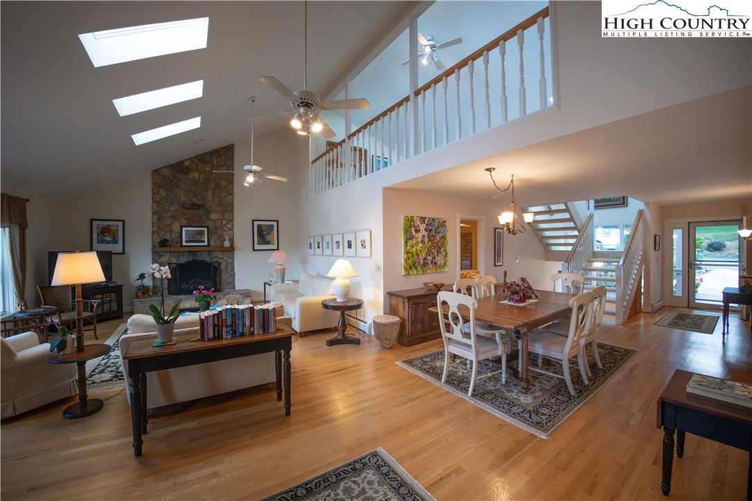 320 Misty Ridge Lane Blowing Rock, NC 28605 - Photo 11 of 46 a living room with furniture a fireplace and a chandelier