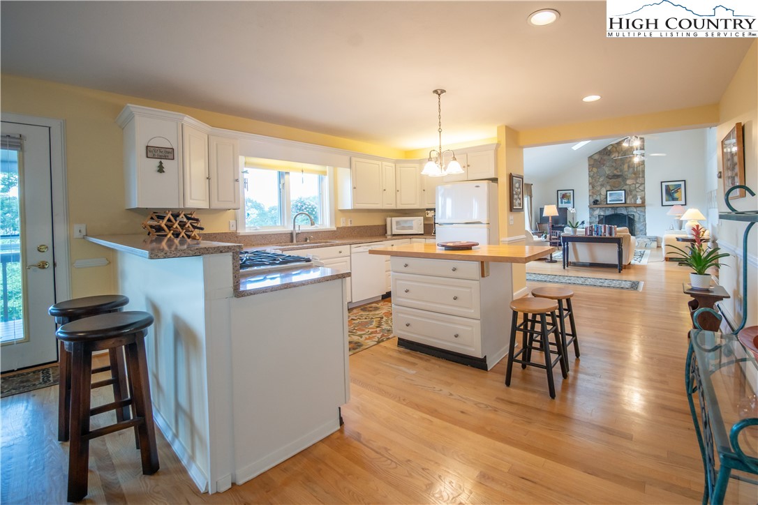 320 Misty Ridge Lane Blowing Rock, NC 28605 - Photo 15 of 46 a kitchen with a table chairs stove and cabinets