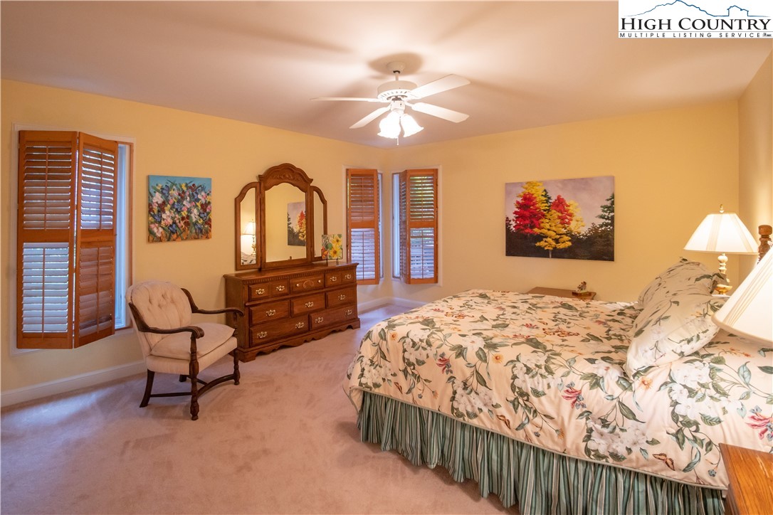 320 Misty Ridge Lane Blowing Rock, NC 28605 - Photo 19 of 46 a bedroom with furniture and a chandelier