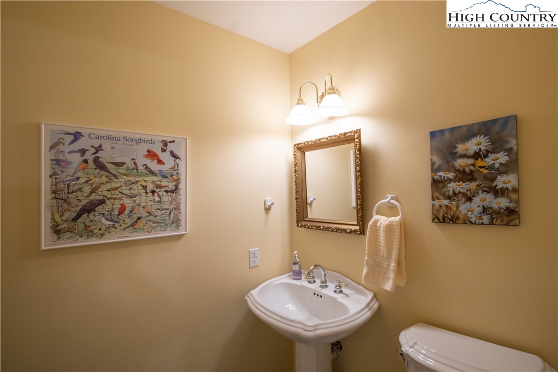 320 Misty Ridge Lane Blowing Rock, NC 28605 - Photo 21 of 46 a bathroom with a toilet sink and mirror