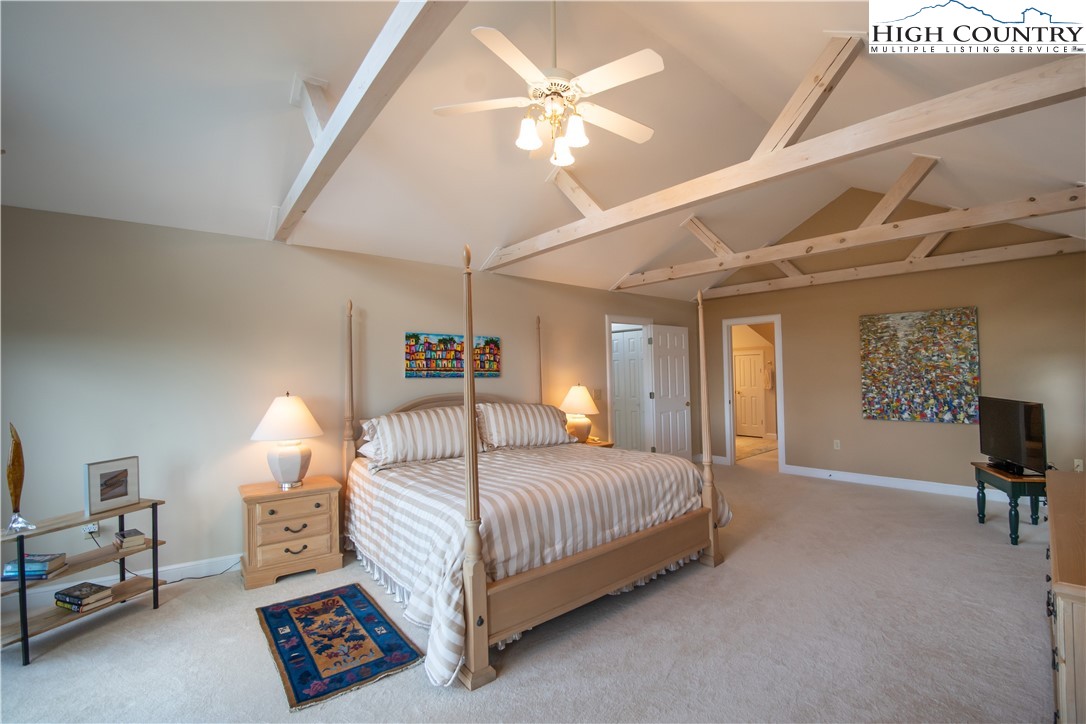 320 Misty Ridge Lane Blowing Rock, NC 28605 - Photo 23 of 46 a bedroom with a bed a table and chair