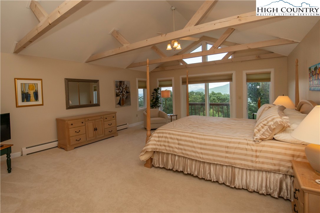 320 Misty Ridge Lane Blowing Rock, NC 28605 - Photo 24 of 46 a bedroom with a large bed and a large window