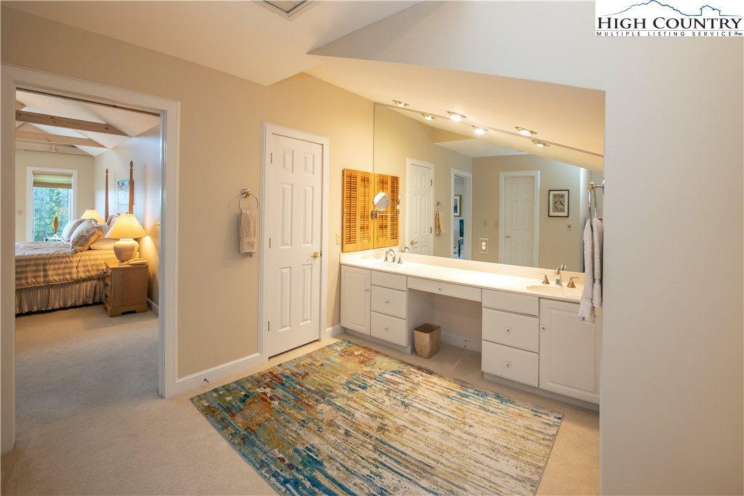 320 Misty Ridge Lane Blowing Rock, NC 28605 - Photo 28 of 46 a en suite bathroom with a sink and a mirror
