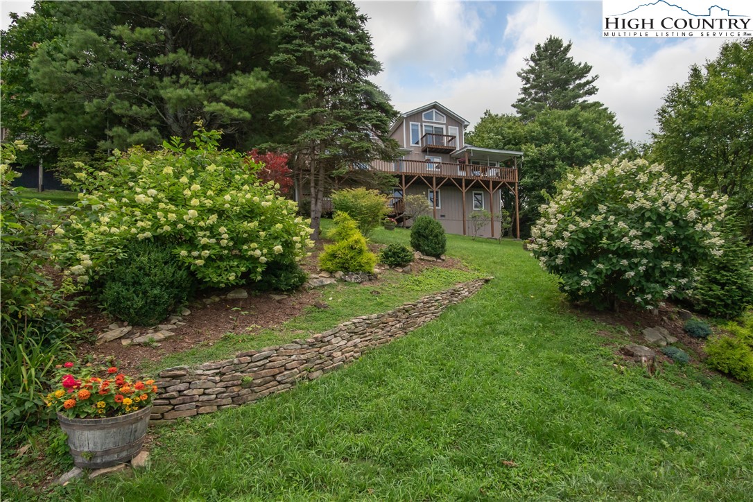 320 Misty Ridge Lane Blowing Rock, NC 28605 - Photo 5 of 46 a view of a garden with a fountain