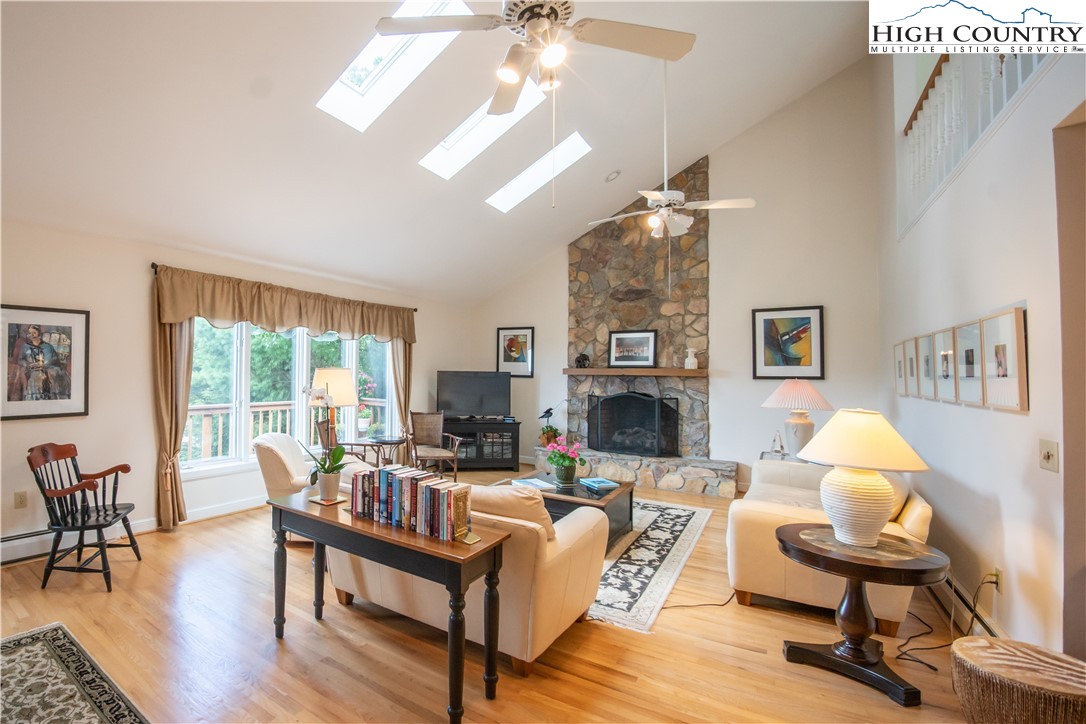 320 Misty Ridge Lane Blowing Rock, NC 28605 - Photo 8 of 46 a living room with furniture fireplace and a large window