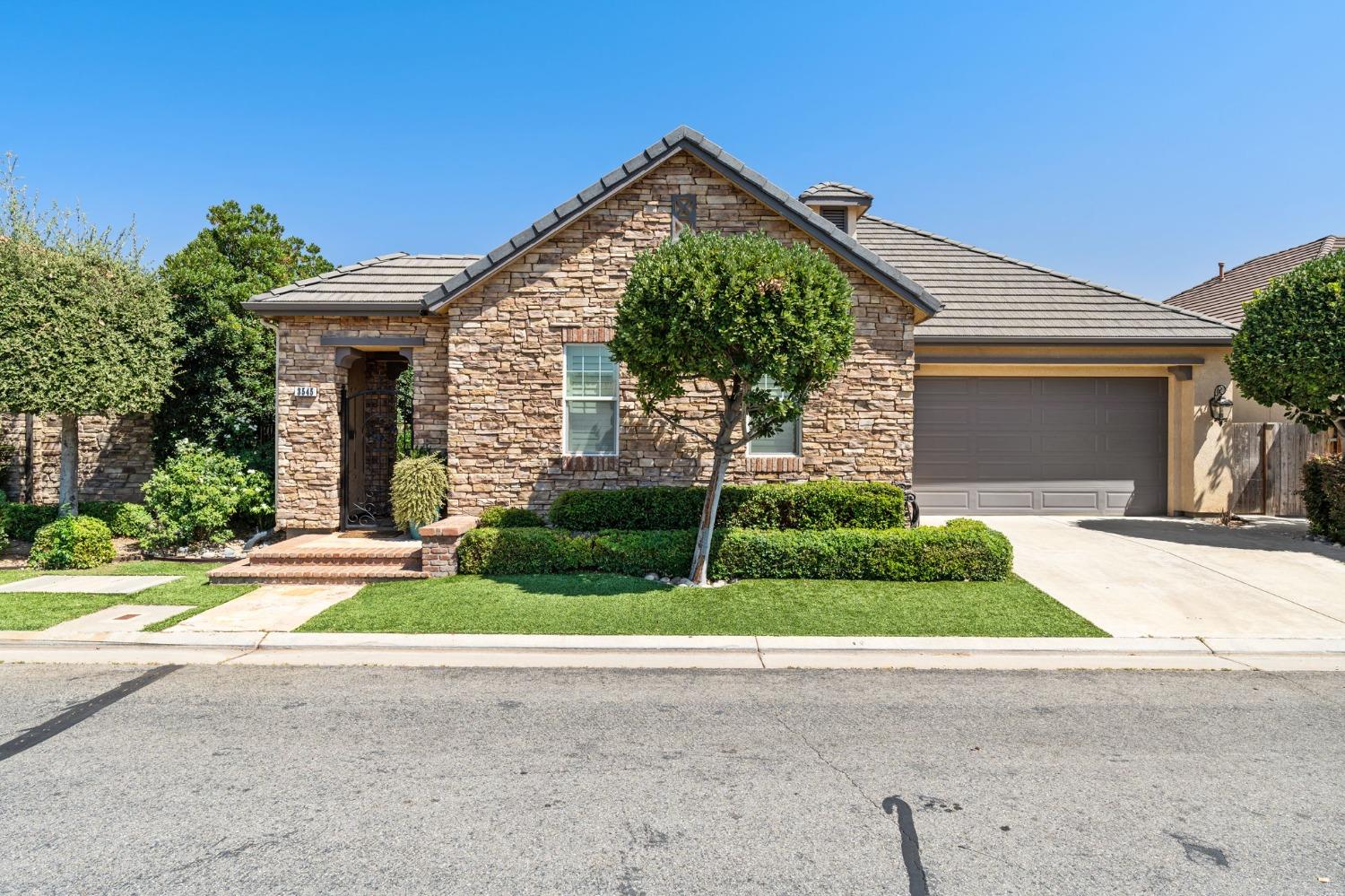 3545 Barclay Square Clovis, CA 93619 - Photo 1 of 31 a front view of a house with a yard and potted plants
