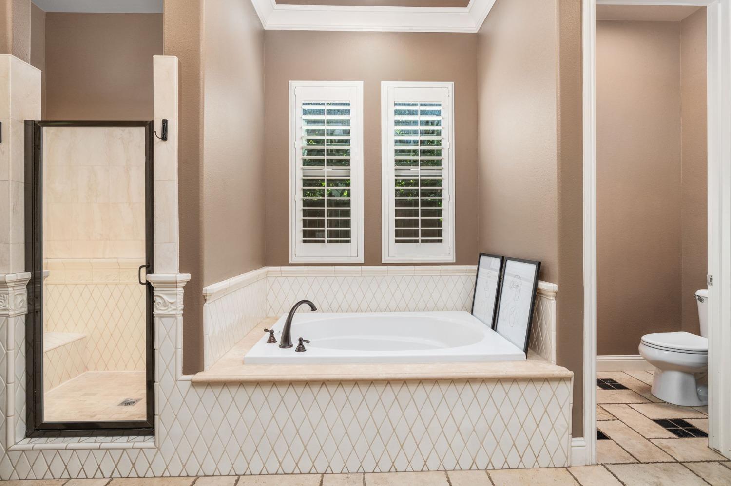 3545 Barclay Square Clovis, CA 93619 - Photo 19 of 31 a bathroom with a bathtub and a window