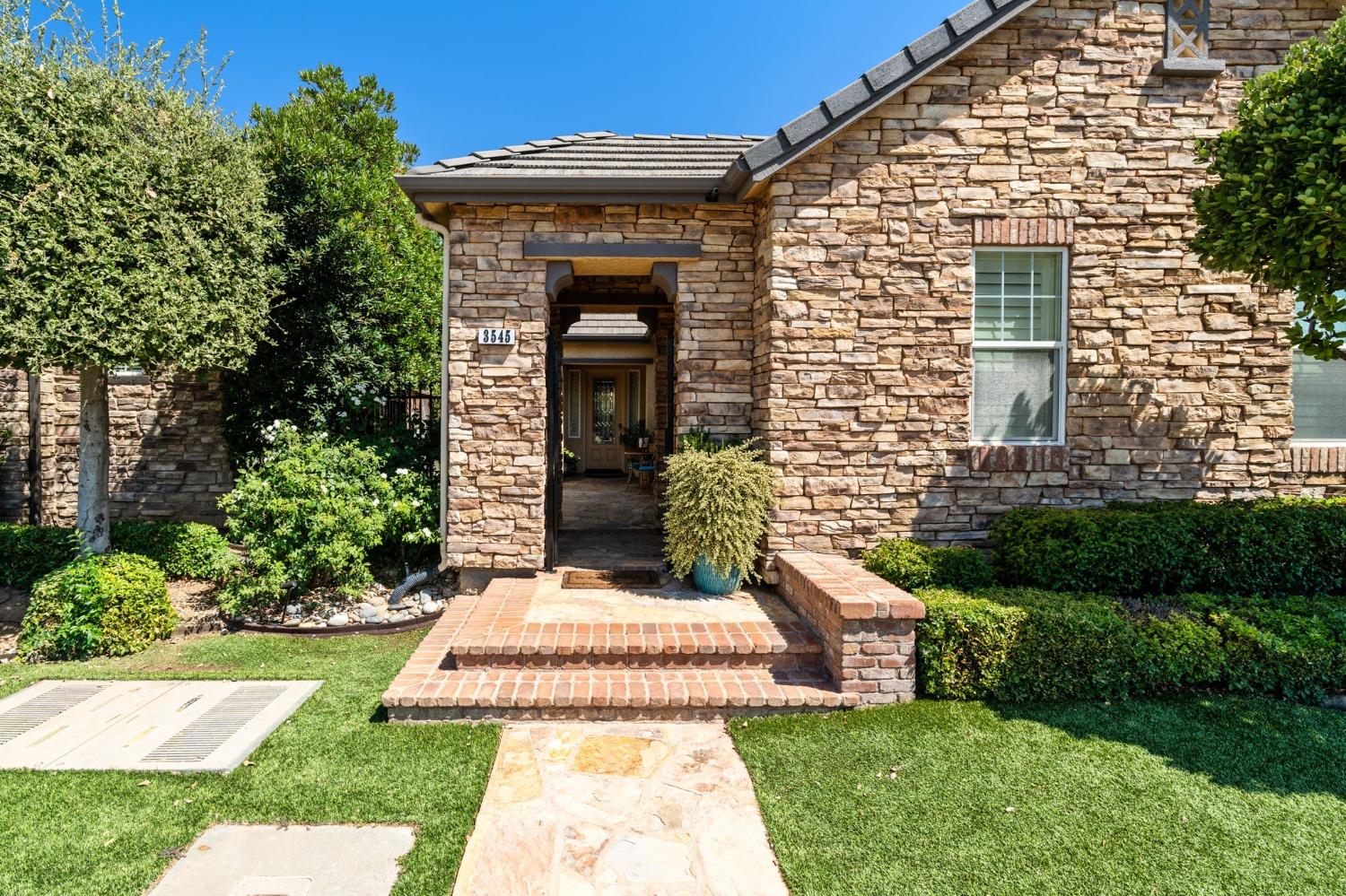 3545 Barclay Square Clovis, CA 93619 - Photo 2 of 31 a front view of a house with a yard