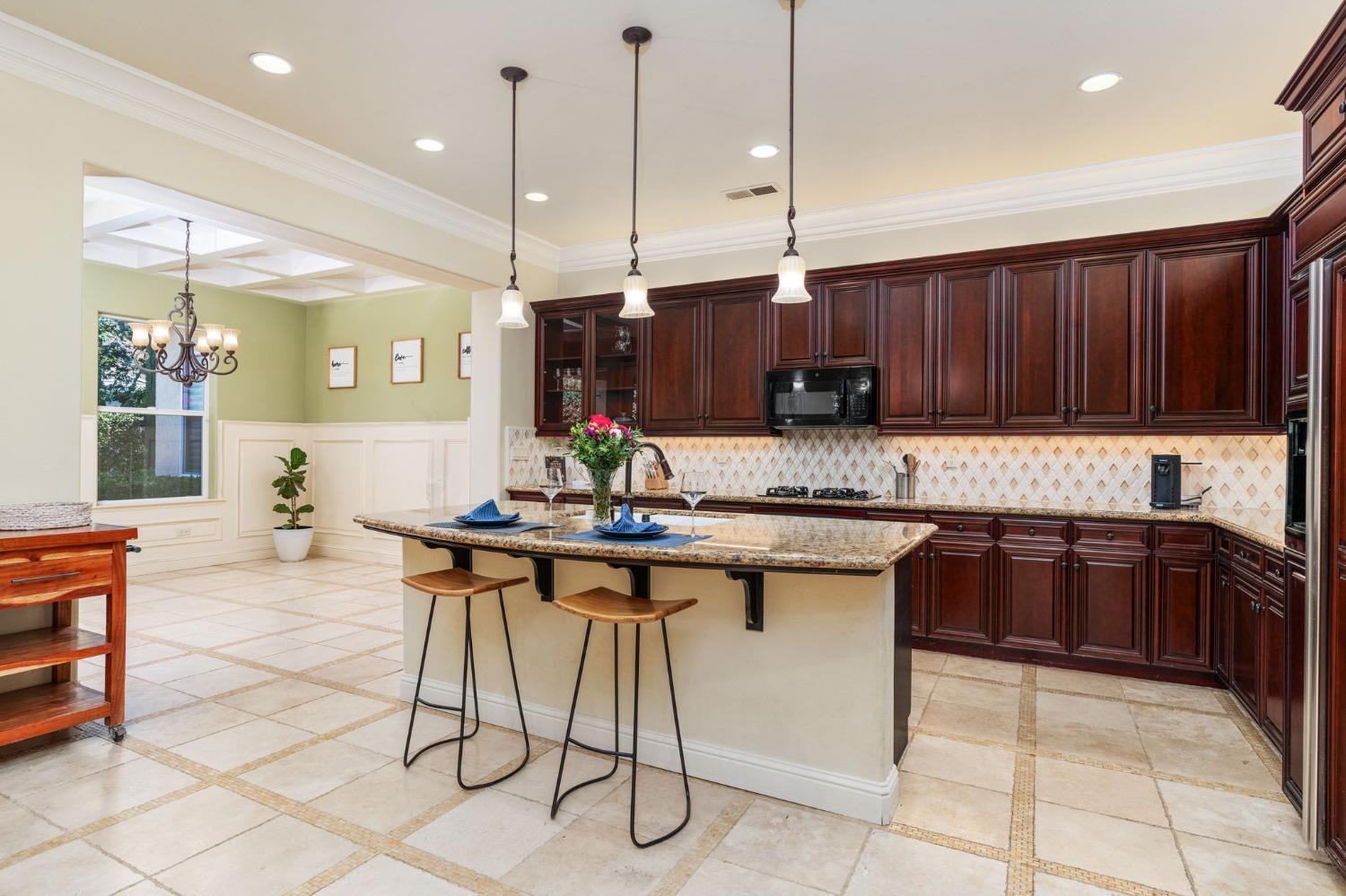 3545 Barclay Square Clovis, CA 93619 - Photo 9 of 31 a kitchen with stainless steel appliances granite countertop a stove a sink island and a refrigerator