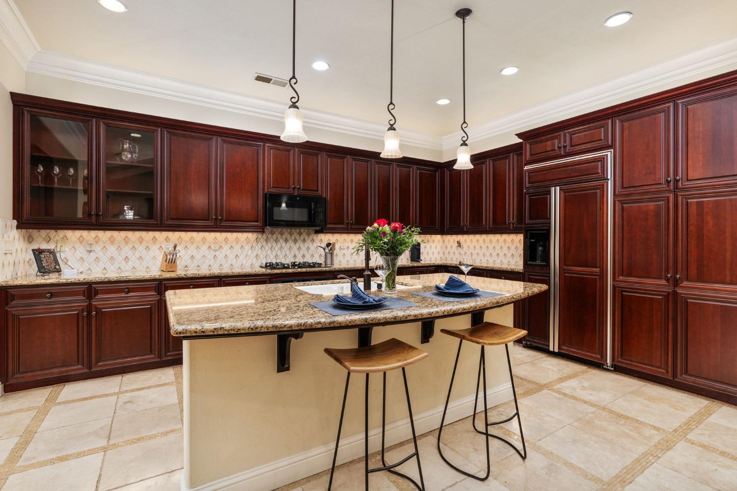 3545 Barclay Square Clovis, CA 93619 - Photo 10 of 31 a kitchen with stainless steel appliances granite countertop wooden cabinets a refrigerator and a sink