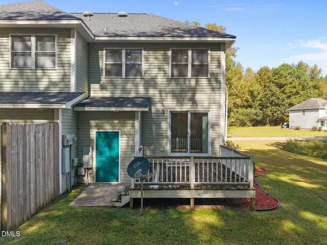 a view of a house with a deck and a chair