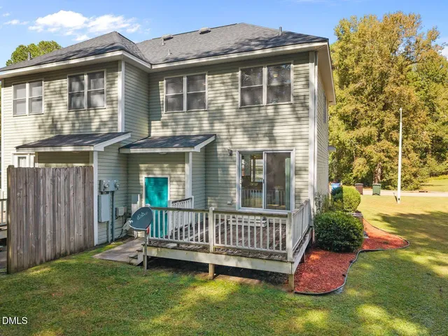 a view of a house with a garden and deck