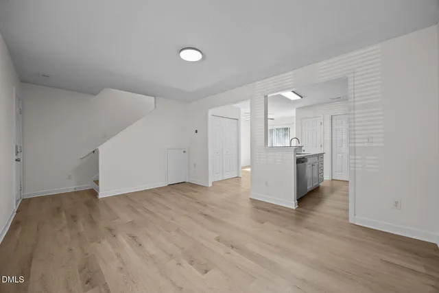 a view of a kitchen with a sink and a refrigerator