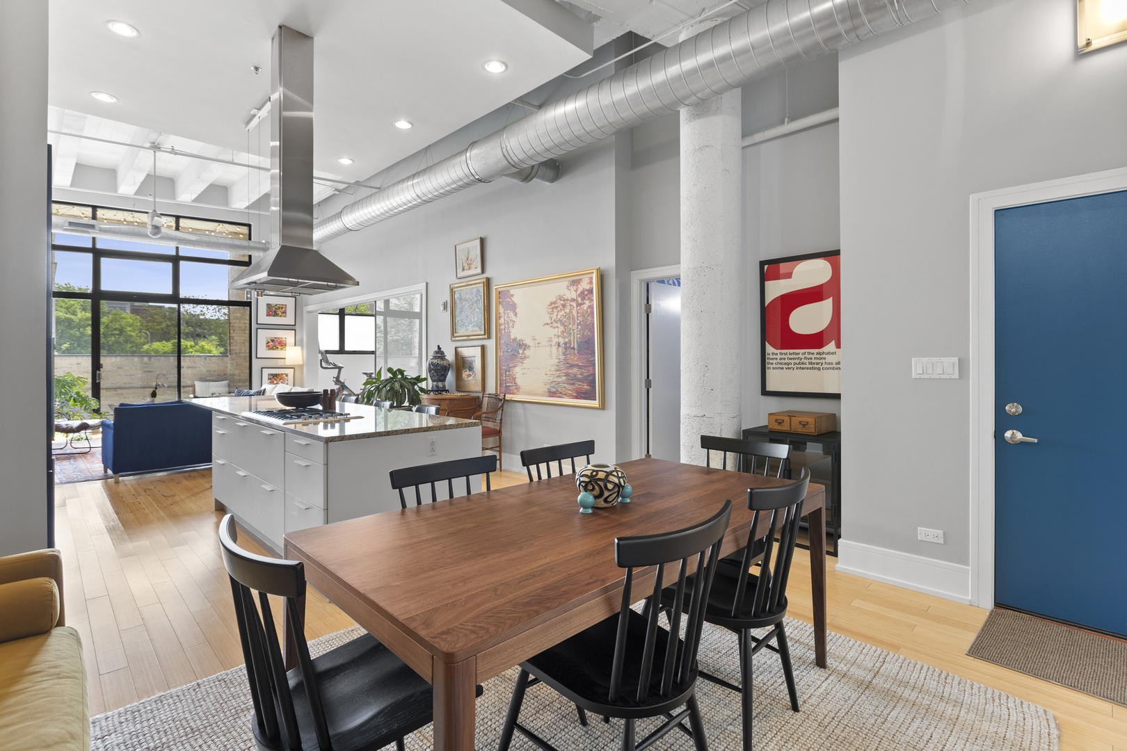 1800 Ridge Avenue, Unit 102 Evanston, IL 60201 - Photo 4 of 26 a dining room with stainless steel appliances kitchen island granite countertop a dining table chairs and a large window