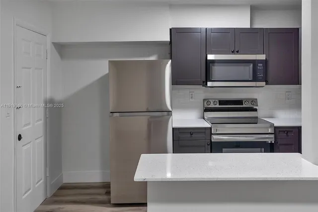 a kitchen with appliances and cabinets