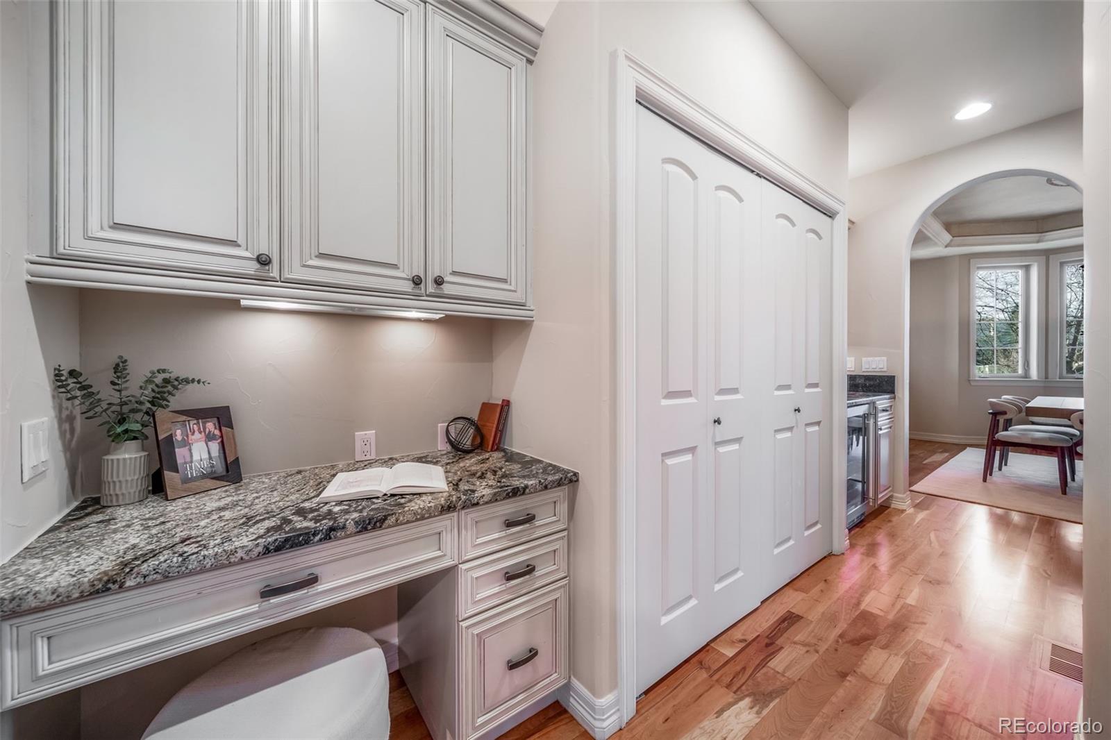 1425 South Elizabeth Street Denver, CO 80210 - Photo 14 of 50 a kitchen with granite countertop white cabinets and white appliances