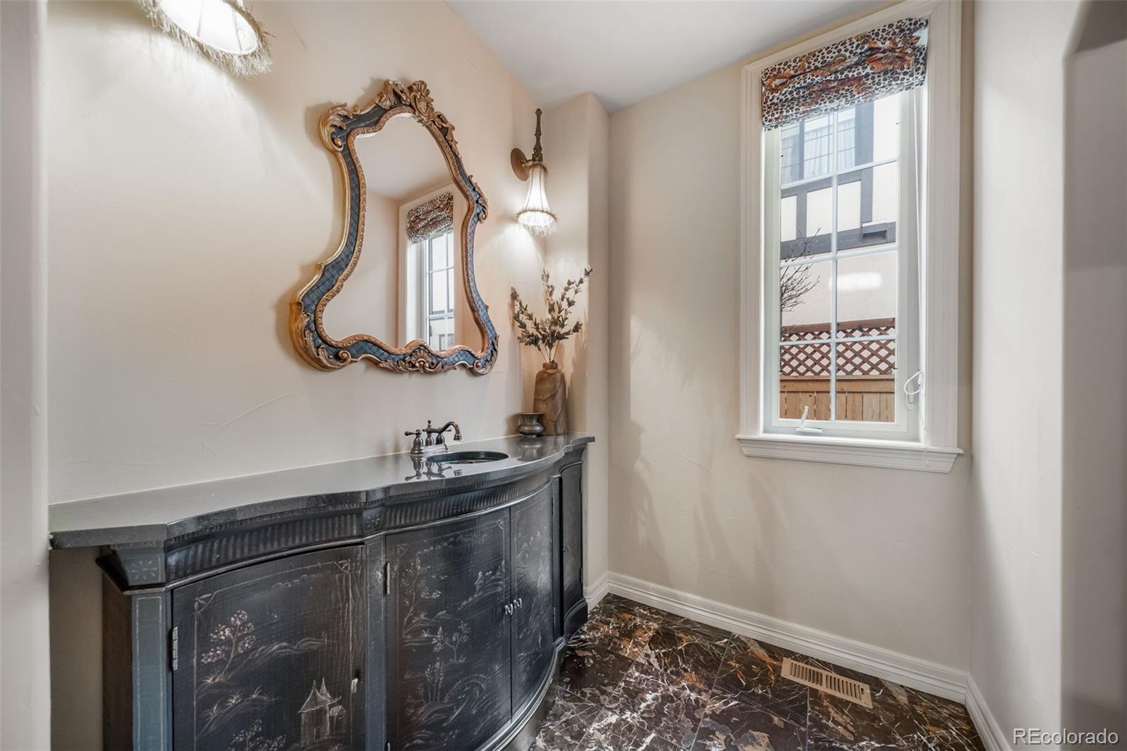 1425 South Elizabeth Street Denver, CO 80210 - Photo 19 of 50 a bathroom with a sink and mirror