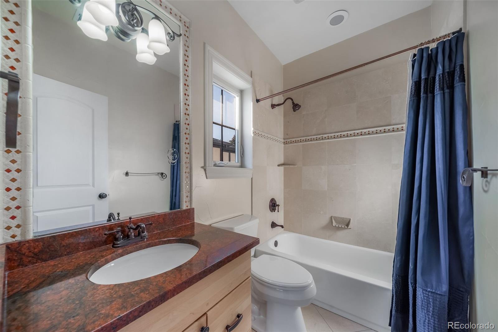 1425 South Elizabeth Street Denver, CO 80210 - Photo 25 of 50 a bathroom with a granite countertop sink a mirror a bathtub and shower
