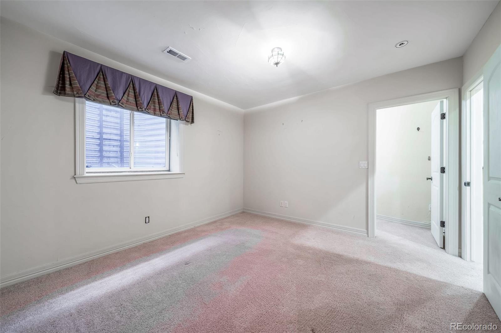 1425 South Elizabeth Street Denver, CO 80210 - Photo 37 of 50 an empty room with windows and closet