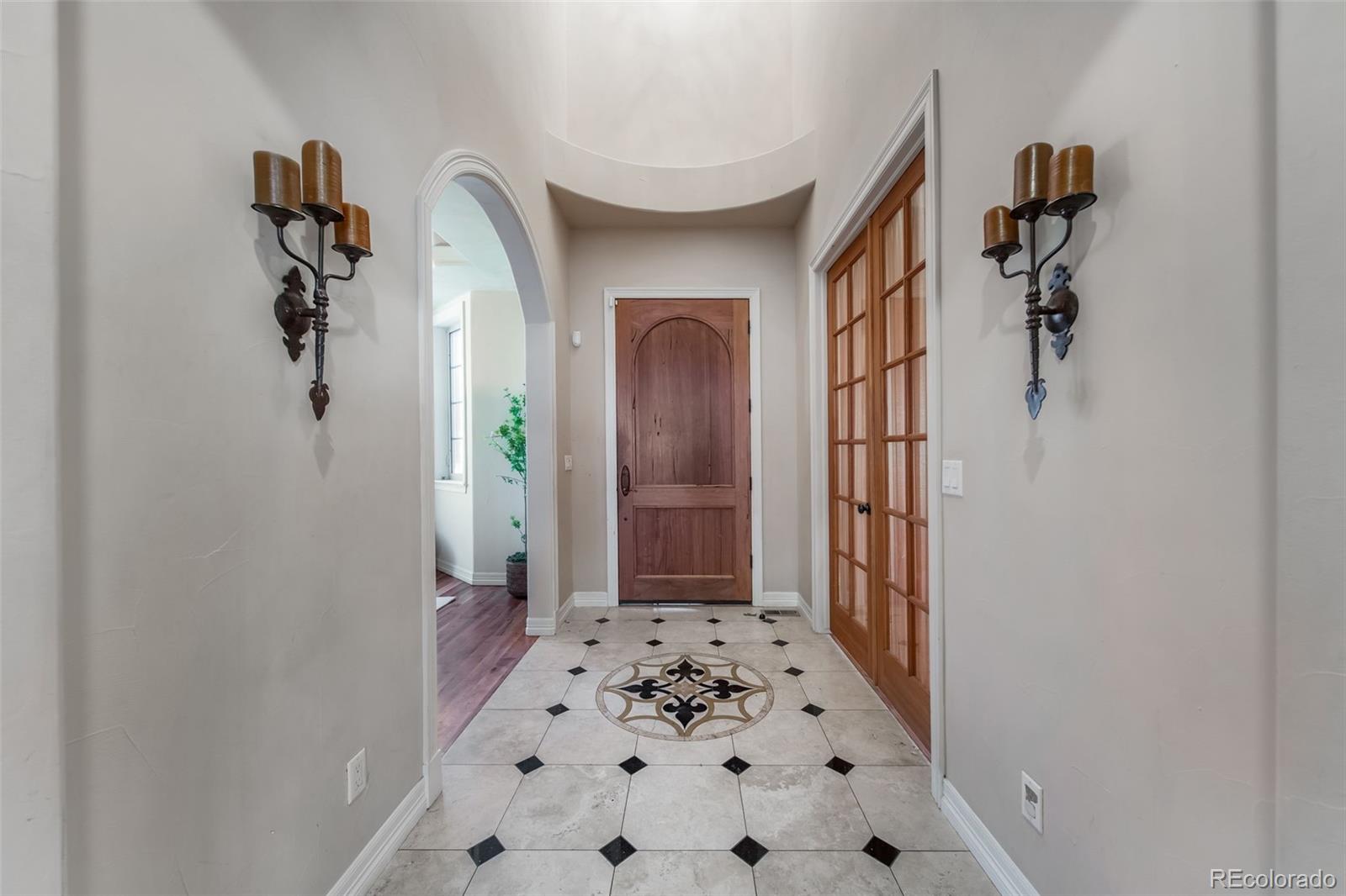 1425 South Elizabeth Street Denver, CO 80210 - Photo 4 of 50 a view of a hallway to a livingroom with wooden floor and a bathroom