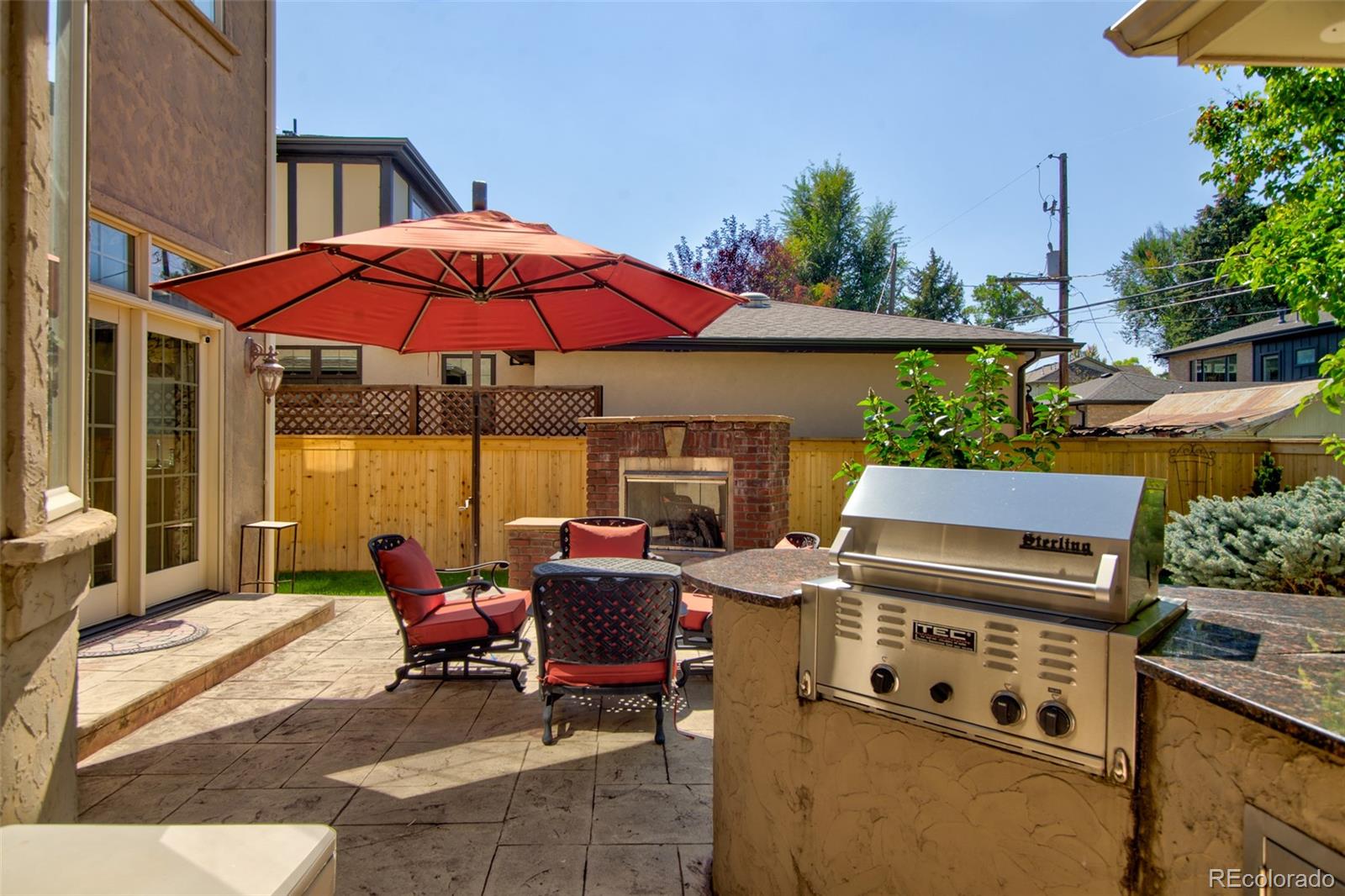 1425 South Elizabeth Street Denver, CO 80210 - Photo 45 of 50 a view of a patio with a table and chairs under an umbrella