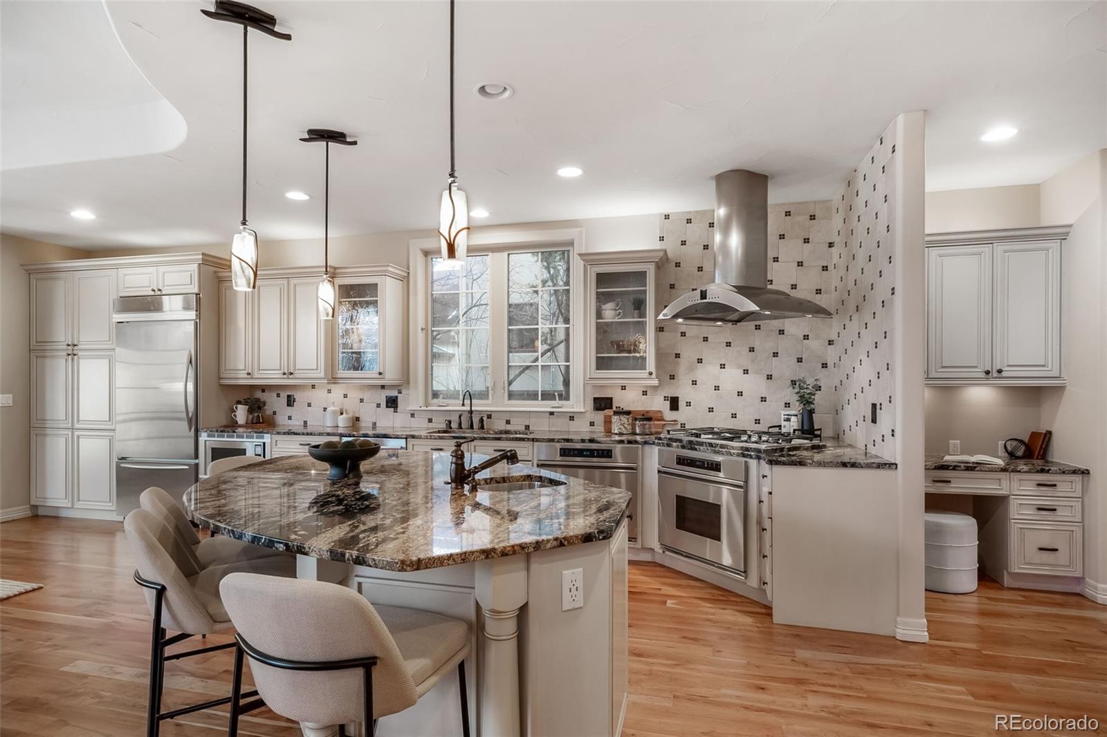 1425 South Elizabeth Street Denver, CO 80210 - Photo 9 of 50 a kitchen with stainless steel appliances kitchen island granite countertop a sink and a stove