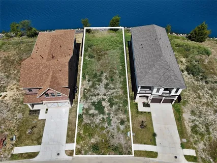 an aerial view of a house with a yard and trees