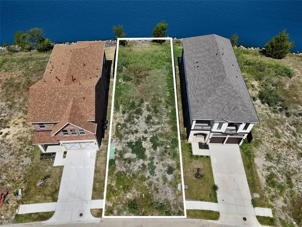 an aerial view of a house with a yard and trees