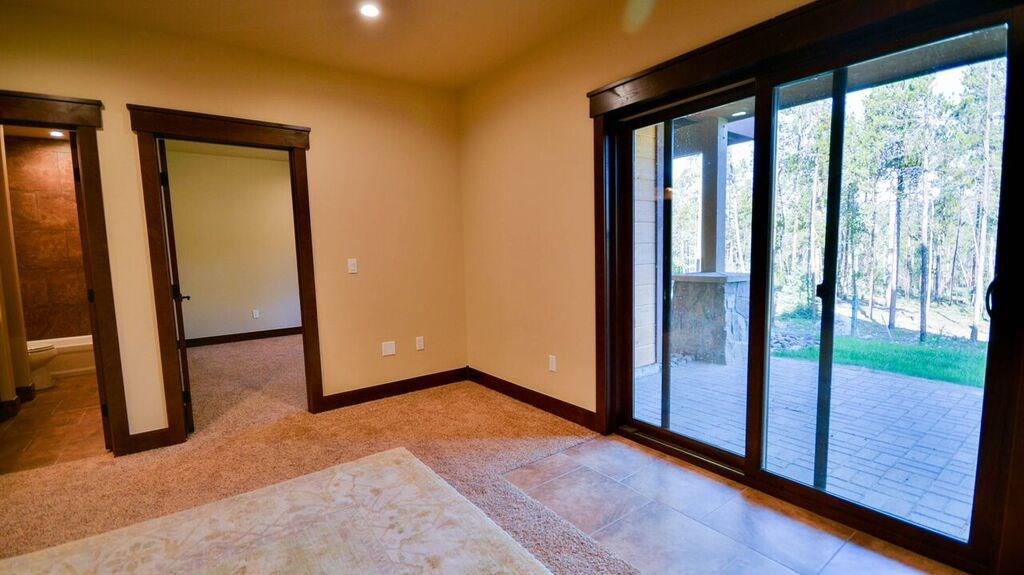698 Independence Road, Unit 7A Keystone, CO 80435 - Photo 17 of 25 an empty room with sliding door and wooden floor
