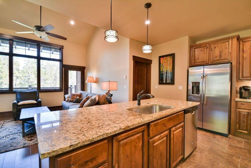 698 Independence Road, Unit 7A Keystone, CO 80435 - Photo 20 of 25 a kitchen with granite countertop a sink and refrigerator