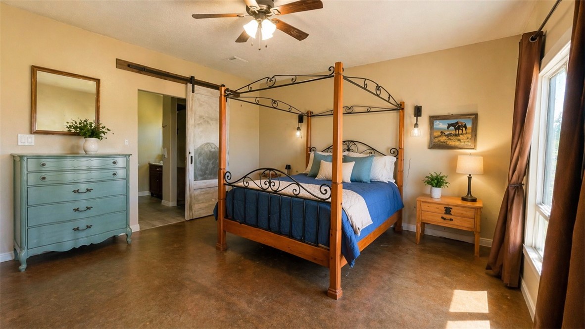11810 Riley Green Road Franklin, TX 77856 - Photo 15 of 36 a bedroom with a bed and a chandelier