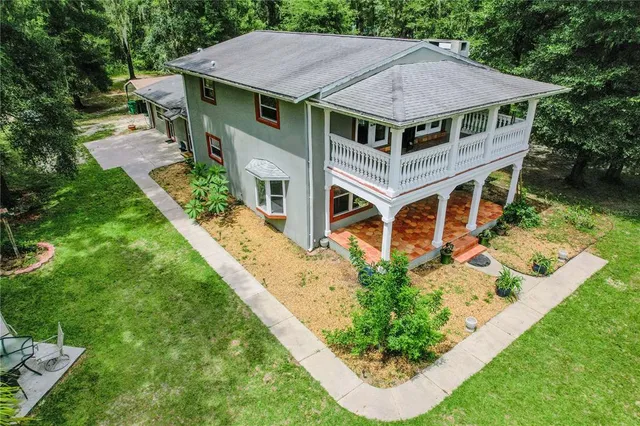 an aerial view of a house with a yard