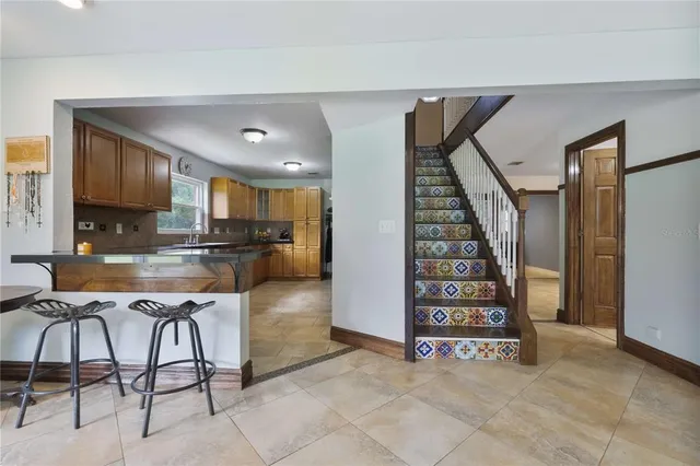 a view of a kitchen with furniture and staircase