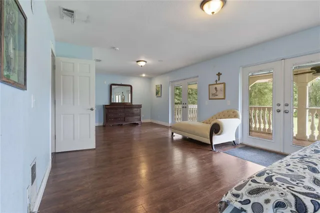 a bedroom with furniture and wooden floor