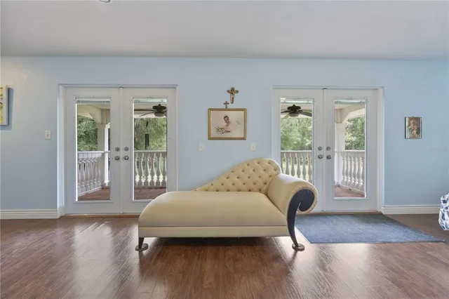 a view of room with wooden floor and windows