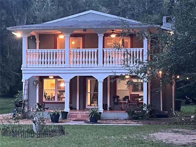 a front view of a house with garden and porch